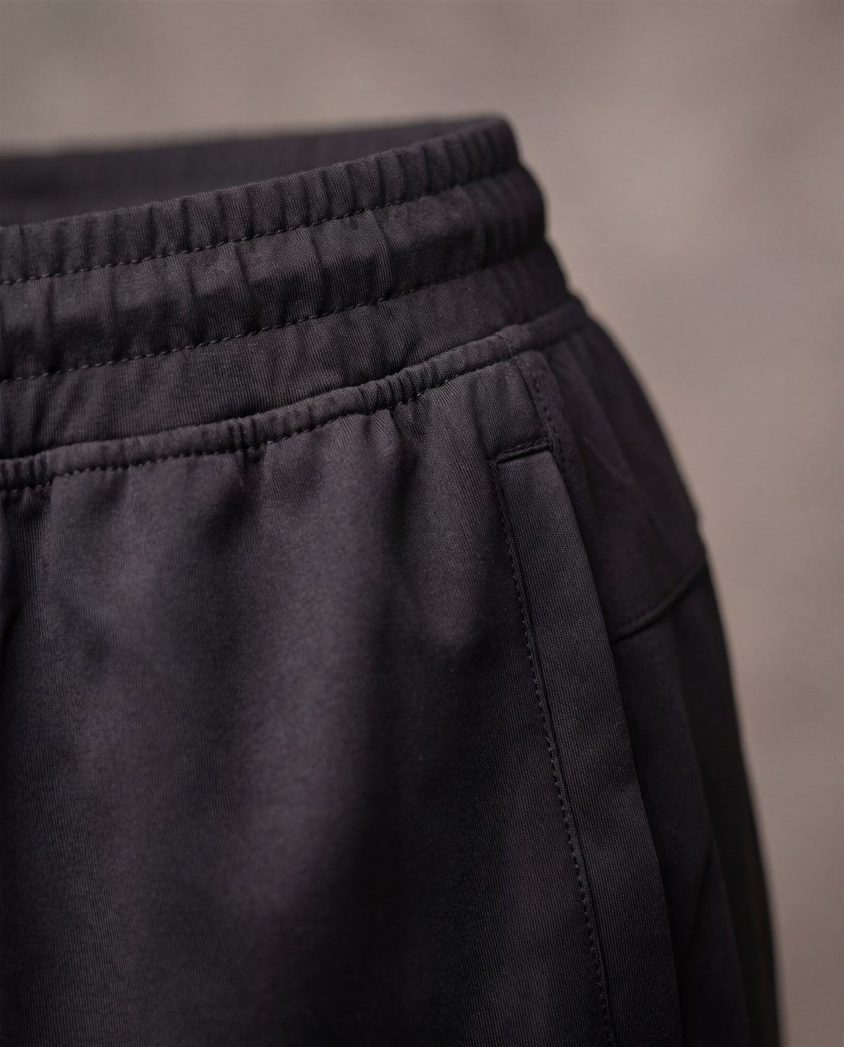 Hopper black poly track pants, fabric and construction close-up