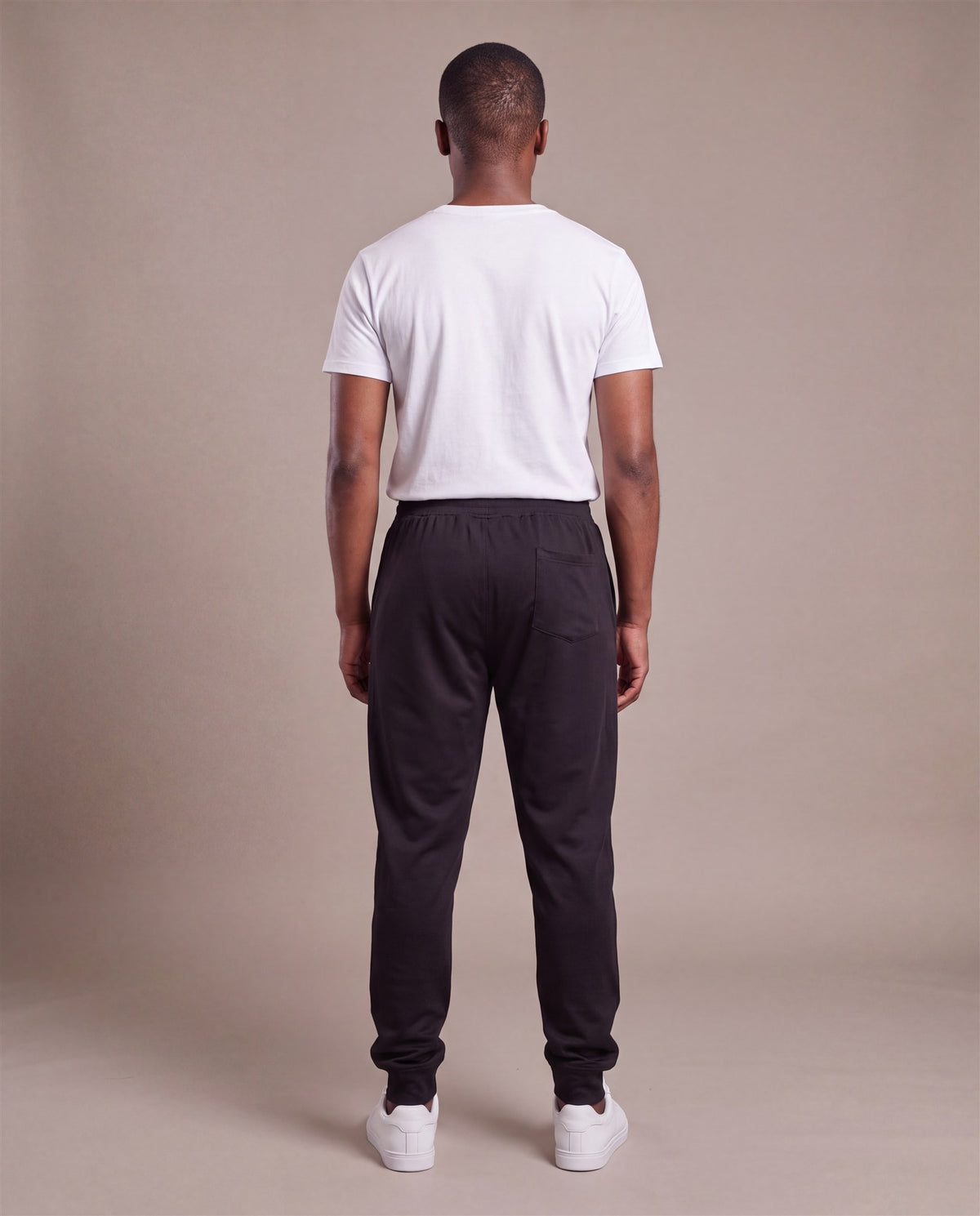 Hopper black poly track pants worn by a model, back