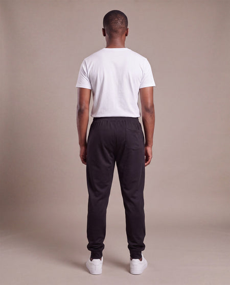 Hopper black poly track pants worn by a model, back