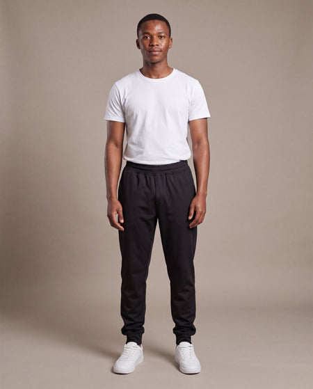 Hopper black poly track pants worn by a model, front