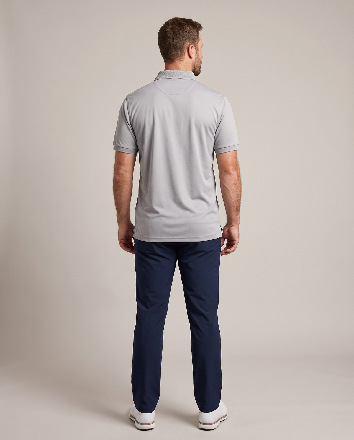 Hopper grey dry-fit golf shirt worn by a model, back view