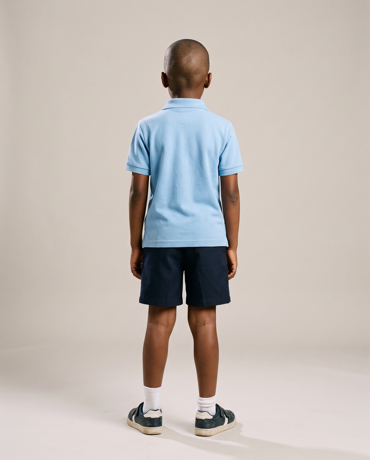 Hopper kids light blue golf shirt worn by a model, back view