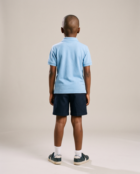 Hopper kids light blue golf shirt worn by a model, back view