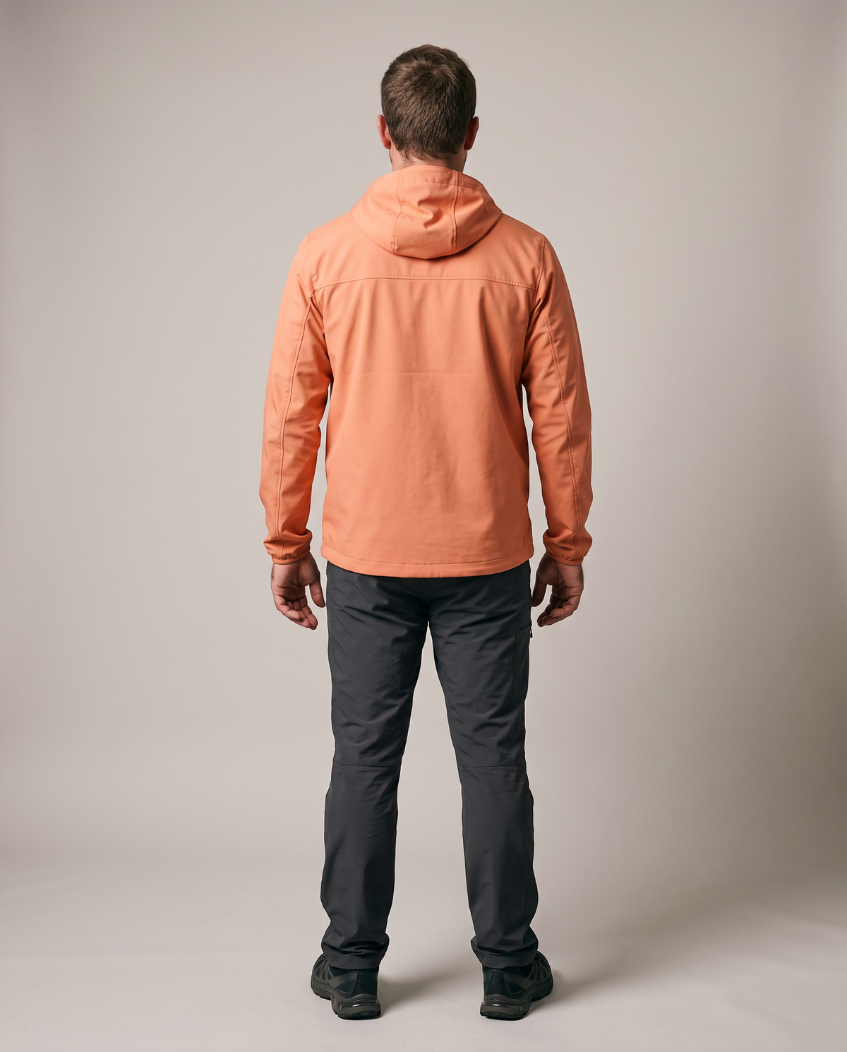 Hopper orange waterproof jacket worn by a model, back view