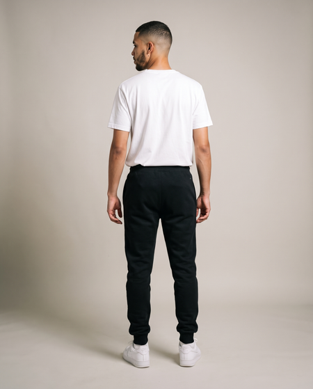 Hopper black fleece track pants worn by a model, back view