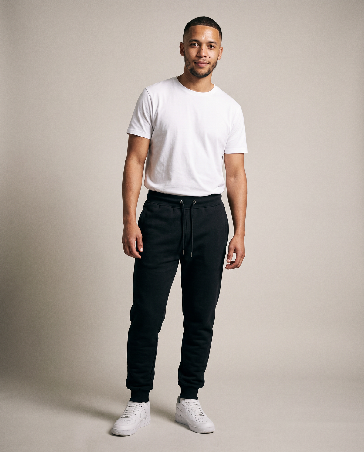Hopper black fleece track pants worn by a model, front view