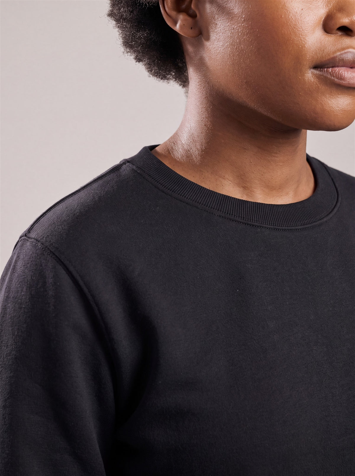 Hopper black 380gsm crewneck sweater, slim ribbed collar close-up on a model