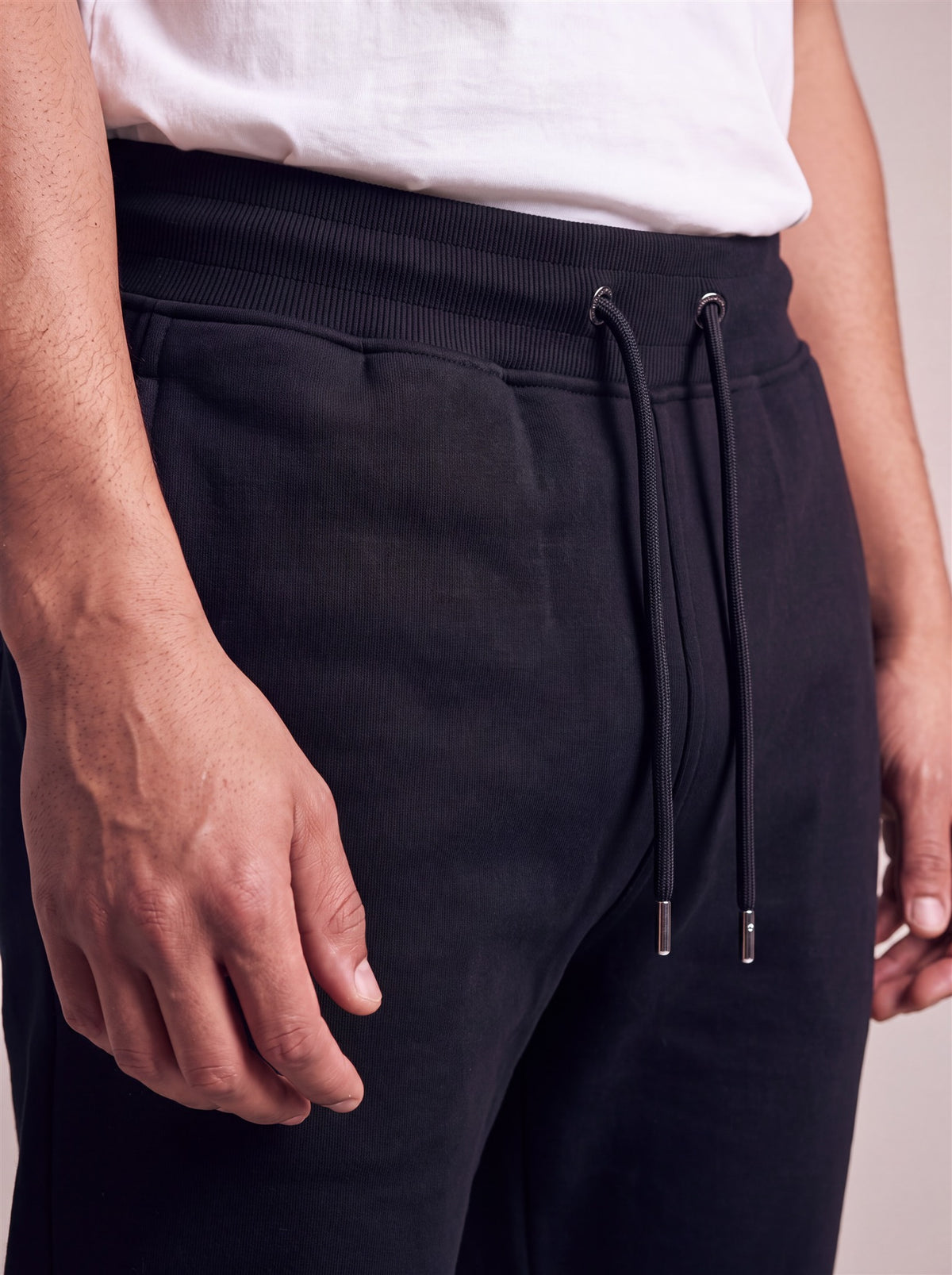 Hopper black french-terry track pants, waistband and drawcord close-up on a model
